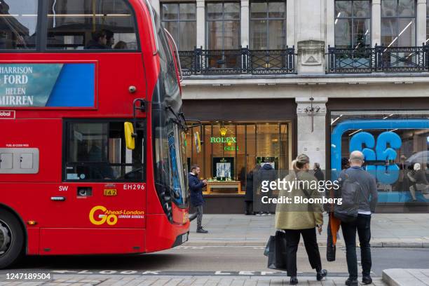 Red London bus passes a Rolex SA luxury watch store on Oxford Street in central London, UK, on Thursday, Feb. 16, 2023. The UKs inflation rate slowed...