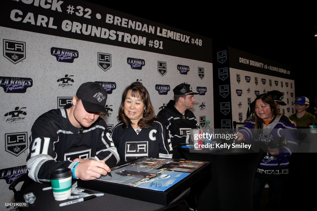 Carl Grundstrom of the Los Angeles Kings and Jonathan Quick sign Carl Grundstrom of the Los Angeles Kings and Jonathan Quick sign