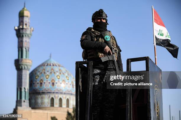 February 2023, Iraq, Baghdad: A member of the Iraqi security forces stands guard as pilgrims march from the centre of Baghdad to the shrine of the...