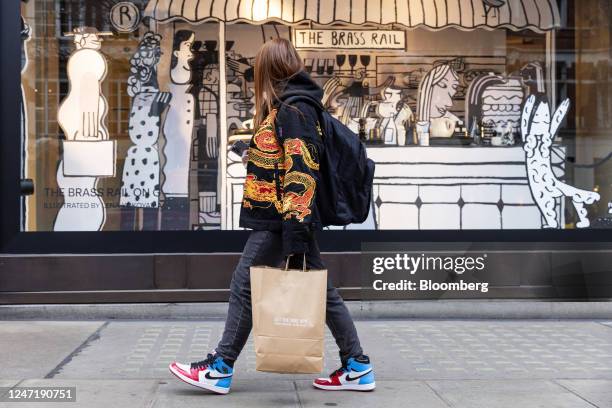 Shopper passes a window display at the Selfridges & Co. Ltd. Luxury department store in central London, UK, on Thursday, Feb. 16, 2023. The UKs...