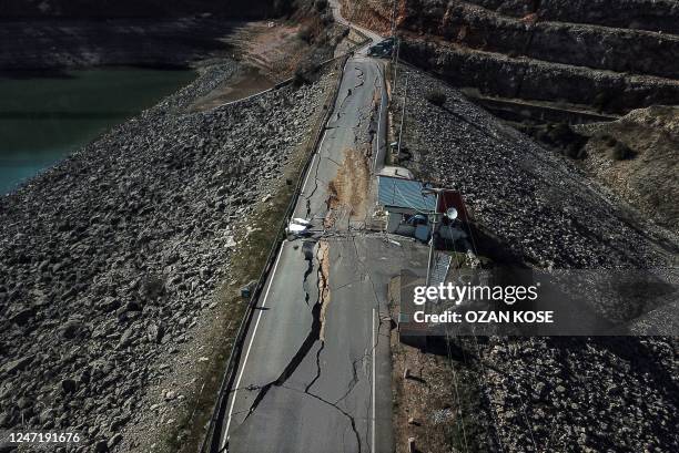 This aerial view taken on February 16, 2023 shows cracks on a road near the earthquakes epicentre in Pazarcik district of the city of Kahramanmaras,...