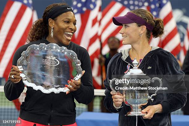 Samantha Stosur of Australia celebrates with the championship trophy alongside Serena Williams of the United States who poses with the second place...