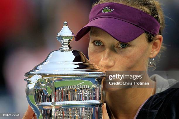 Samantha Stosur of Australia celebrates with the championship trophy after defeating Serena Williams of the United States to win the Women's Singles...