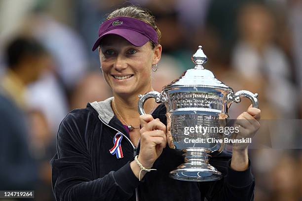 Samantha Stosur of Australia celebrates with the championship trophy after defeating Serena Williams of the United States to win the Women's Singles...