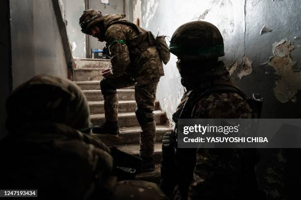 Ukrainian servicemen of the State Border Guard Service wait for an order to move to the mortar position at the entrance of the shelter in Bakhmut on...