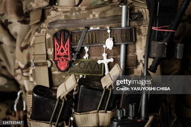 The cross is seen on the jacket of Ukrainian servicemen of the State Border Guard Service in the shelter in Bakhmut on February 16 as the head of...