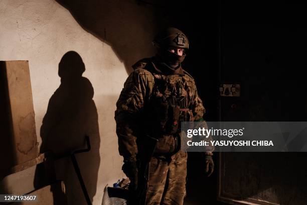 Ukrainian serviceman of the State Border Guard Service stands in the shelter in Bakhmut on February 16 as the head of Russia's mercenary outfit...