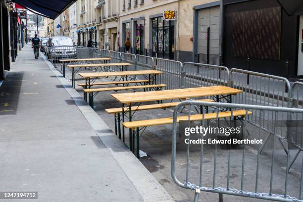 Empty tables set up at a terrace on the street between parking spaces, as bars and restaurants reopen after two months of nationwide restrictions due...