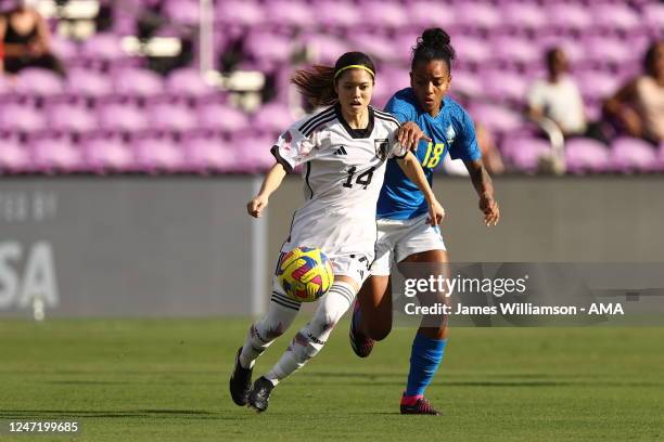Yui Hasegawa of Japan and Geyse of Brazilduring the 2023 SheBelieves Cup match between Japan and Brazil at Exploria Stadium on February 16, 2023 in...