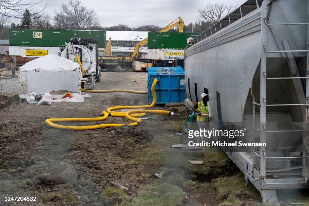 Worker cleans the inside of a train car near the derailment site on February 16, 2023 in East Palestine, Ohio. On February 3rd, a Norfolk Southern...
