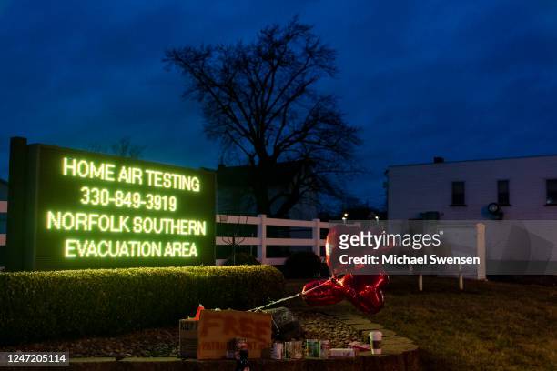 Balloons are placed next to a sign displaying information for residents to receive air-quality tests from Norfolk Southern Railway on February 16,...