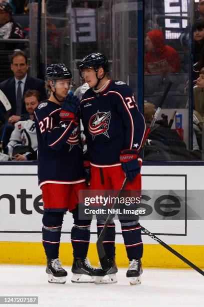 Adam Boqvist and Patrik Laine of the Columbus Blue Jackets talk during the third period of a game against the Winnipeg Jets at Nationwide Arena on...