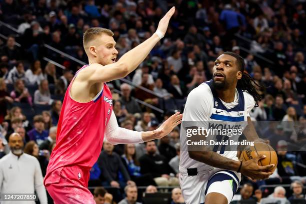 Naz Reid of the Minnesota Timberwolves drives to the net while Kristaps Porzingis of the Washington Wizards defends in the second quarter of the game...