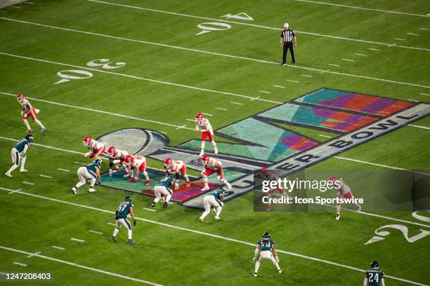 Kansas City Chiefs quarterback Patrick Mahomes prepares to take a snapper the Super Bowl LVII logo during the Super Bowl LVII game between the...