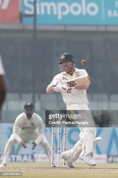 David Warner of Australia is hit in the helmet by the ball try to play shot during day one of the Second Test match in the series between India and...