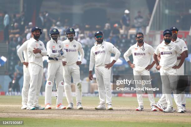 India players wait for a DRS review during day one of the Second Test match in the series between India and Australia at Arun Jaitley Stadium on...