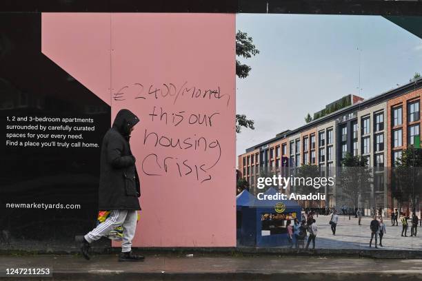 The inscription on the fence of the construction site '2400 euros/month, this is our housing crisis' seen in Dublin city center, Ireland on February...