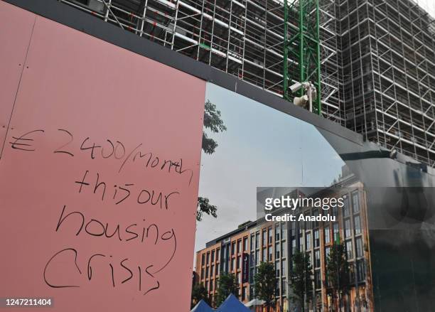 The inscription on the fence of the construction site '2400 euros/month, this is our housing crisis' seen in Dublin city center, Ireland on February...