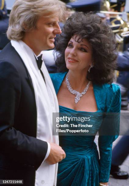 English actress and author Joan Collins with her husband Peter Holm at the film premiere of "Biggles" in London on 23rd May 1986.