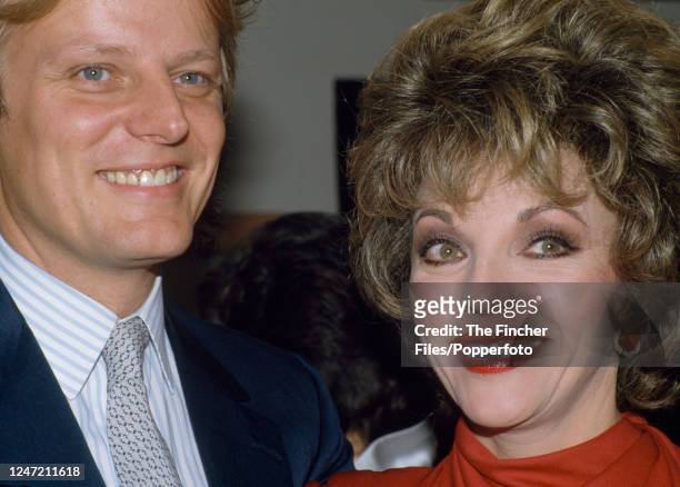 English actress and author Joan Collins with her husband Peter Holm in London, circa 1985.