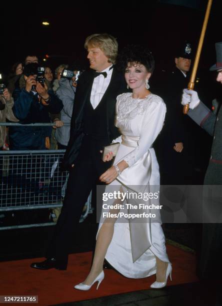 English actress and author Joan Collins with her husband Peter Holm in London, circa 1986.