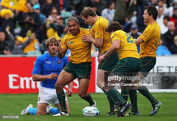 Digby Ioane of the Wallabies celebrates his try with team mates during the IRB 2011 Rugby World Cup Pool C match between Australia and Italy at North...