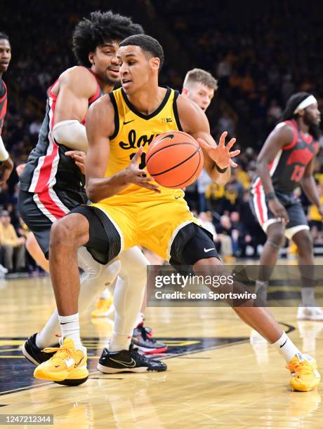 Iowa forward Kris Murray struggles to control the ball while guarded by Ohio State forward Justice Sueing during a college basketball game between...