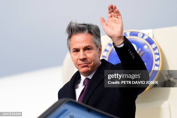 Secretary of State Antony Blinken waves as he arrives at the airport in Munich, southern Germany, where he will attend the Munich Security Conference...