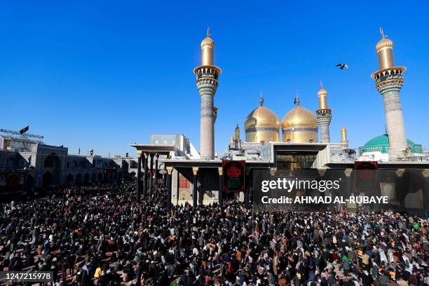 Shiite Muslim pilgrims gather to pray at the shrine of the 8th-century Imam Musa al-Kadhim in the Kadhimiya district, north of Baghdad, on February...
