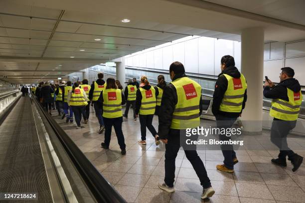 Ground services employees from the Verdi union protest march through the airport during strike action at Munich International Airport in Munich,...