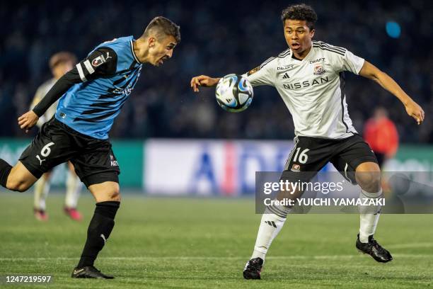 Kawasaki Frontale's midfielder Joao Schmidt competes for the ball with Yokohama F. Marino's midfielder Joel Chima Fujita during the J-League football...