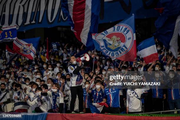 Fans celebrate the victory of Yokohama F. Marinos during the J-League football match between Kawasaki Frontale and Yokohama F. Marinos at Todoroki...