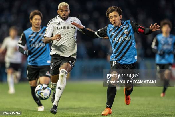 Kawasaki Frontale's defender Shintaro Kurumaya competes for the ball with Yokohama F. Marino's forward Anderson Lopes during the J-League football...