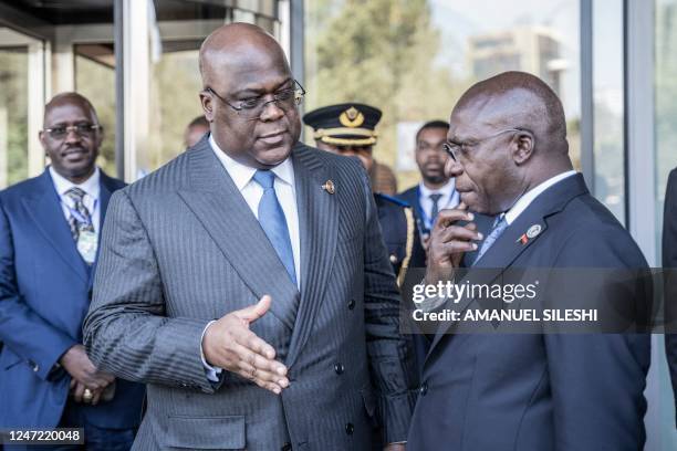 Democratic Republic of Congo President Felix Tshisekedi talks with Angola's Foreign Minister Tete Antonio as they leave the venue of a mini-summit on...