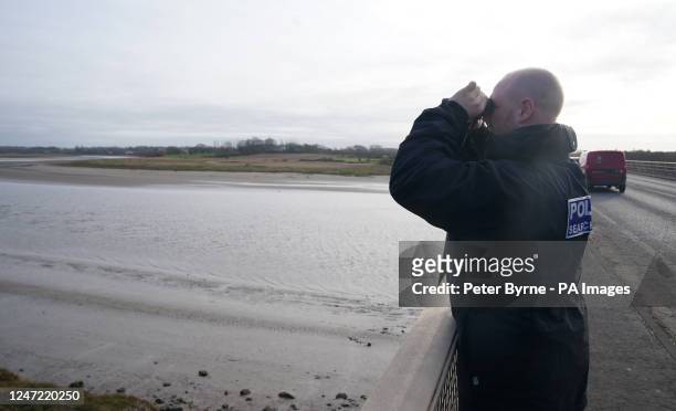 Police officer on the Shard Bridge on the River Wyre in Hambleton, Lancashire, as police continue their search for missing woman Nicola Bulley who...