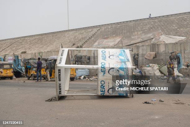 General view of a toppled traffic officer booth in Agege, Lagos on February 17 where violence flared up earlier in the day. - Protesters attacked...