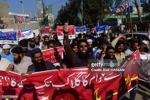 Activists of Pakistan Markazi Muslim League carry placards and chant anti-government slogans during a protest against the inflation and price hike in...