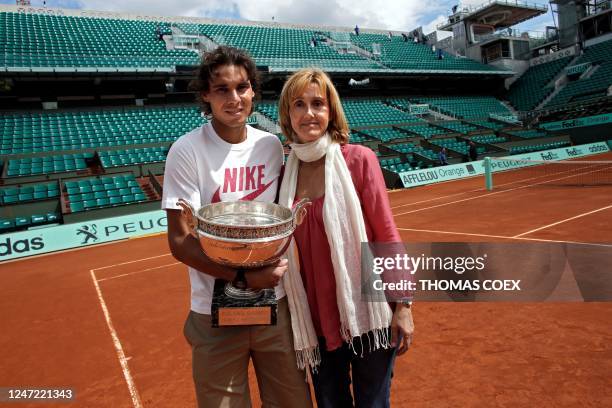 This photograph taken on June 11, 2012 shows Spanish tennis player Rafael Nadal posing with the trophy and his mother Ana Maria Parera after he won...