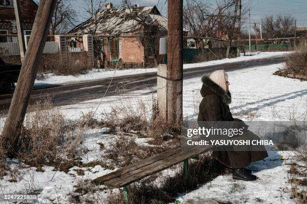 Mariya sits on a bench waiting to receive her pension from a postal delivery van in Siversk on February 17 amid the Russian invasion of Ukraine.