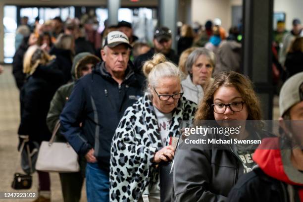People wait in line at the Norfolk Southern Assistance Center to collect a $1000 check and get reimbursed for expenses while they were evacuated...