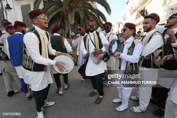 Libyans gather at the Martyrs' Square in Libya's capital Tripoli on February 17 as they commemorate the 12th anniversary of the uprising that toppled...