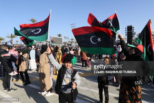 Libyans gather at the Martyrs' Square in Libya's capital Tripoli on February 17 as they commemorate the 12th anniversary of the uprising that toppled...