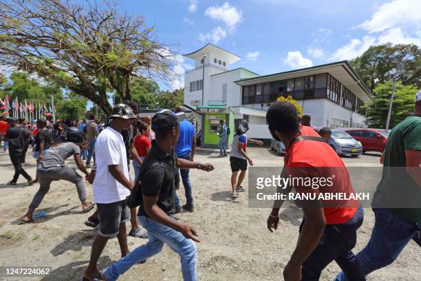 People attack the National Assembly during a protest against government economic policies in Paramaribo, on February 17, 2023. - Hundreds of people...