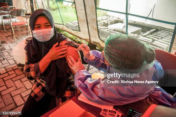 Woman receives a second booster dose of COVID-19 vaccine in Yogyakarta, Indonesia, Feb. 16, 2023.