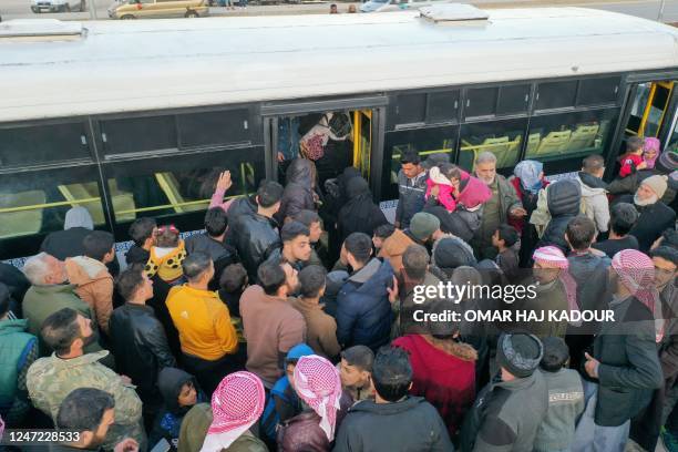 An aerial picture shows Syrian refugees living in Turkey waiting to take a bus through the northern Bab al-Hawa border crossing, on February 17 as...