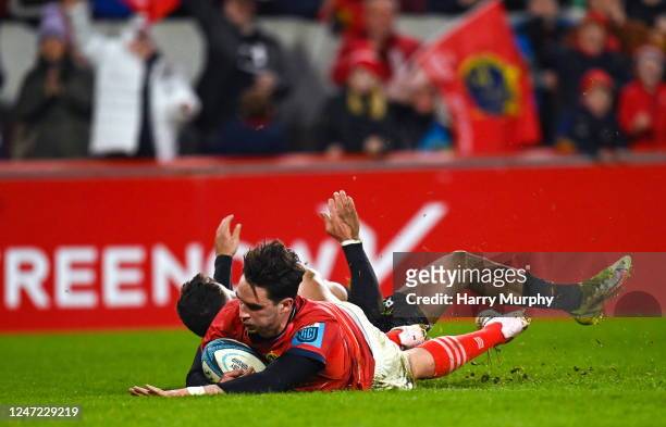 Limerick , Ireland - 17 February 2023; Joey Carbery of Munster scores his side's fourth try despite the tackle of Luke Morgan of Ospreys during the...