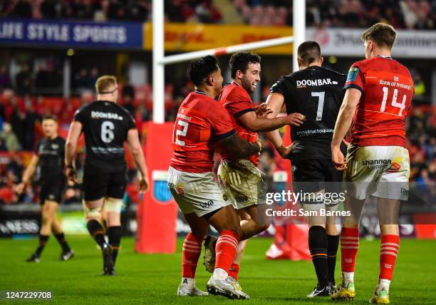 Limerick , Ireland - 17 February 2023; Paddy Patterson of Munster, centre, celebrates with team-mates Malakai Fekitoa, left, and Liam Coombes, right,...