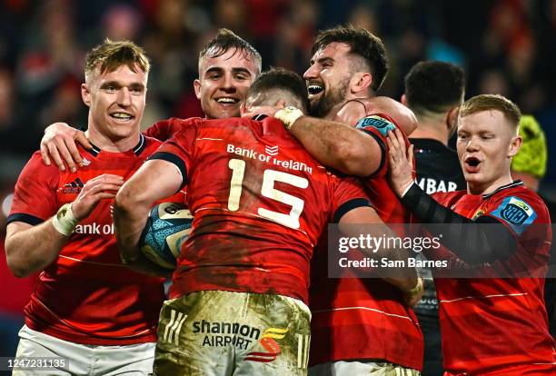 Limerick , Ireland - 17 February 2023; Shane Daly of Munster is congratulated by team-mates after scoring his side's eighth try during the United...