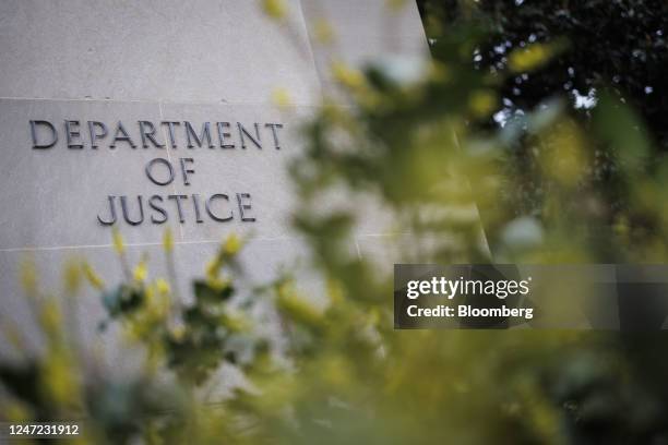 Signage outside the US Department of Justice headquarters in Washington, DC, US, on Friday, Feb. 17, 2023. The Justice Department is shifting its...