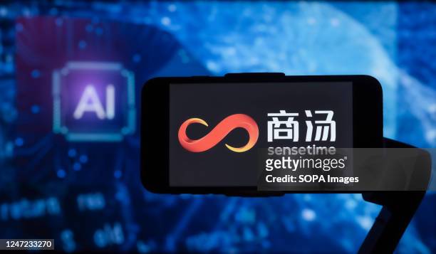 In this photo illustration, the logo of SenseTime is seen displayed on a mobile phone screen with AI written in the background.